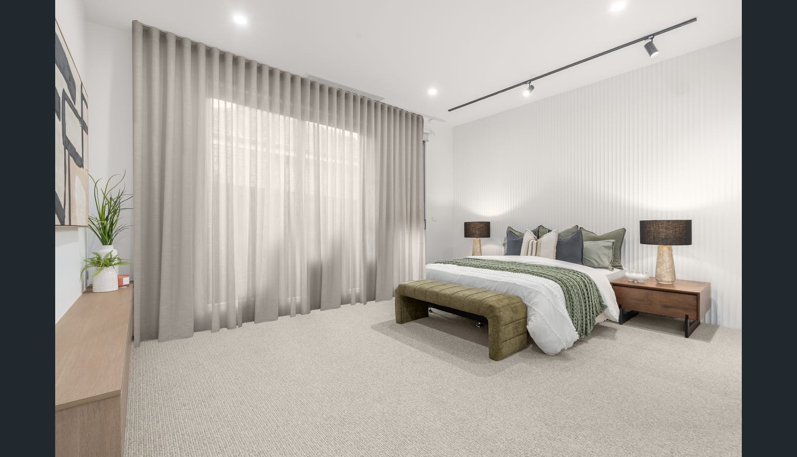Completed large bedroom with pale carpet