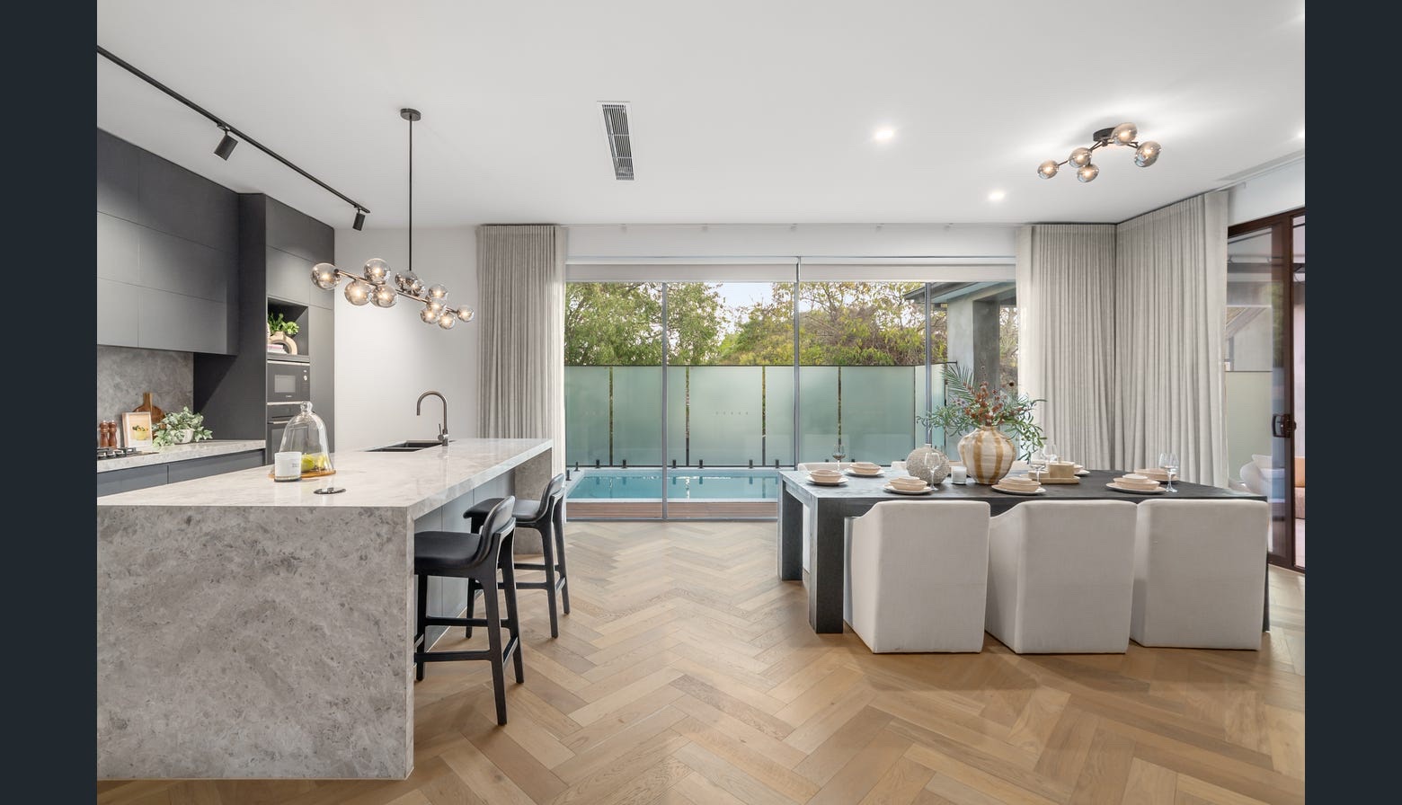 Completed open-plan kitchen and dining room with herringbone flooring